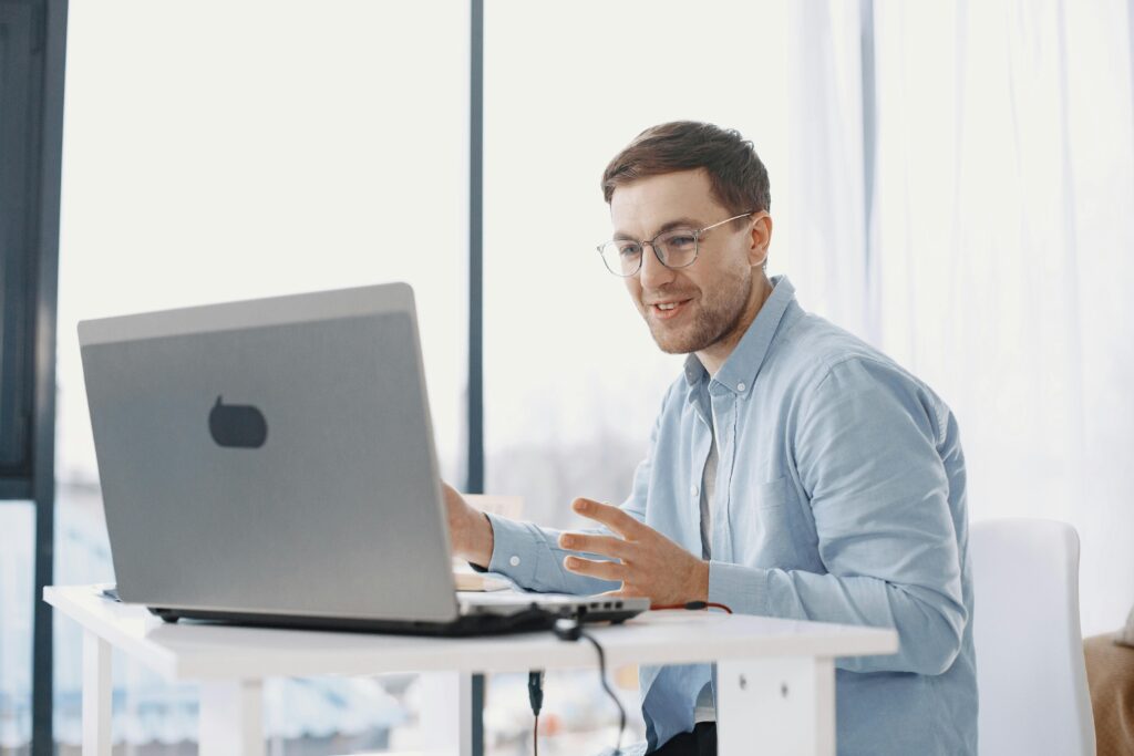 Man working from home using a laptop, illustrating a modern remote work lifestyle. Photographer: Gustavo Fring